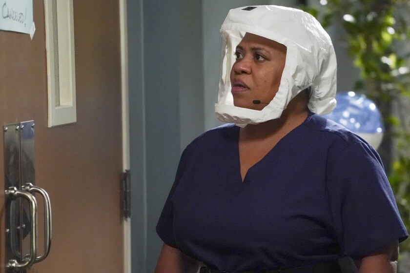 Chandra Wilson wearing scrubs and a clear face mask on "Grey's Anatomy" on ABC.