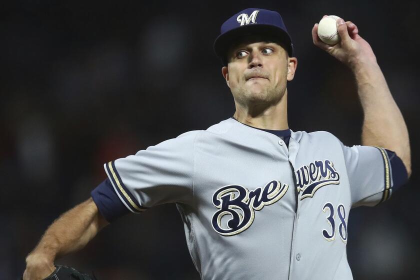 Milwaukee Brewers pitcher Dan Jennings works against the San Francisco Giants during the ninth inning of a baseball game Saturday, July 28, 2018, in San Francisco. (AP Photo/Ben Margot)