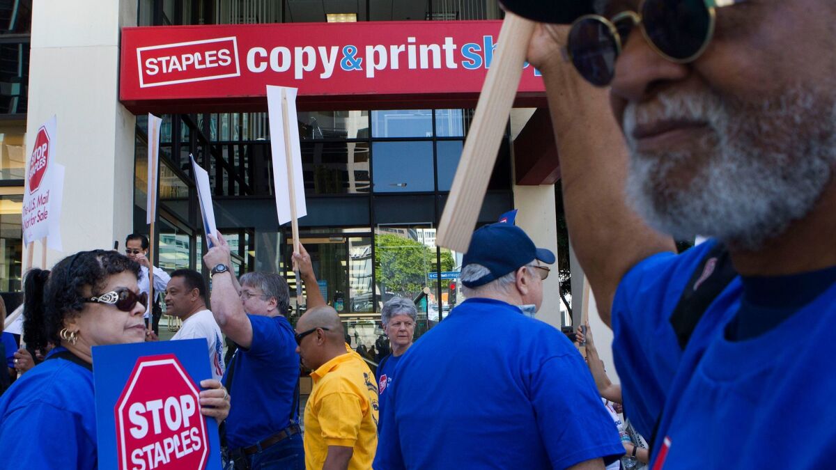 Protesters picket in front of a Staples store in downtown Los Angeles in 2014. The American Postal Workers Union waged a three-year campaign against the chain because of Staples' partnership with the U.S. Postal Service.