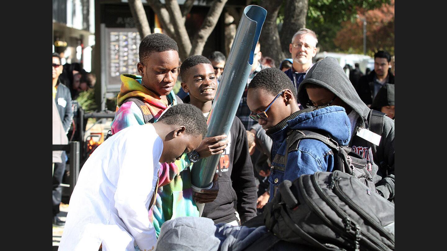 The team from Tanzania brings their invention into the competitor's square at JPL's annual Invention Challenge on Friday, December 2, 2016. 28 teams, including a team from Tanzania, but mostly of local Southern California schools, competed. The challenge was to transfer a specific amount of water over a distance to a collection cup on the other side. Methods included catapults, conveyor belts, a lot of duct tape, and pvc.
