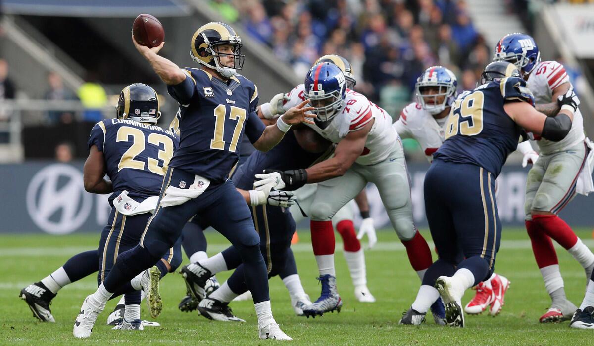 Rams quarterback Case Keenum cocks his arm to pass against the New York Giants at Twickenham Stadium in London. He was intercepted four times.
