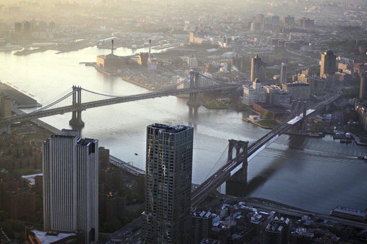 A view of the Manhattan Bridge, left, and Brooklyn Bridge over the East River as seen from the 105th floor of One World Trade Center in New York. In the wake of Superstorm Sandy, which swamped the city and killed 40 residents, storm evacuation zones are being expanded.