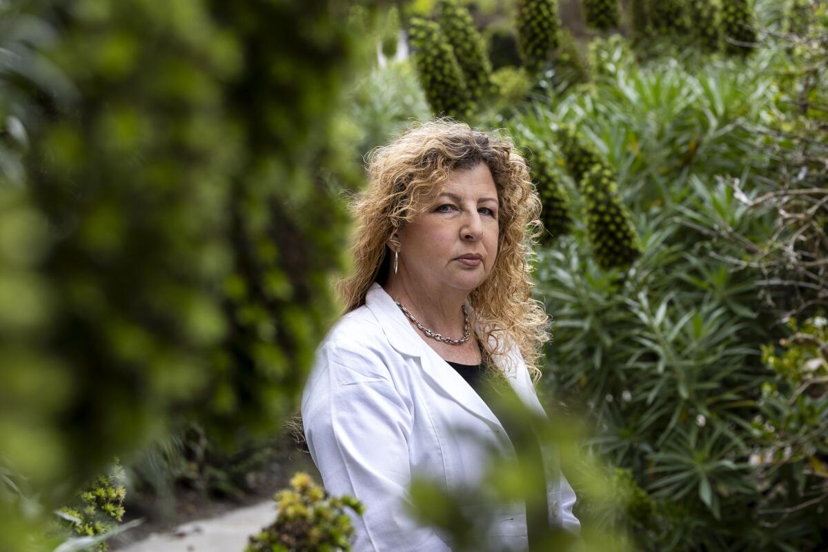 Dr. Bonni Goldstein surrounded by foliage in a park.