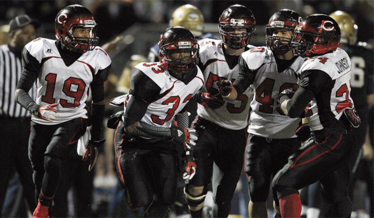 John Plattenburg (33) is swarmed by Corona Centennial teammates after making an interception in November 2012. Plattenburg played last year for Houston Lamar and is now headed for USC.