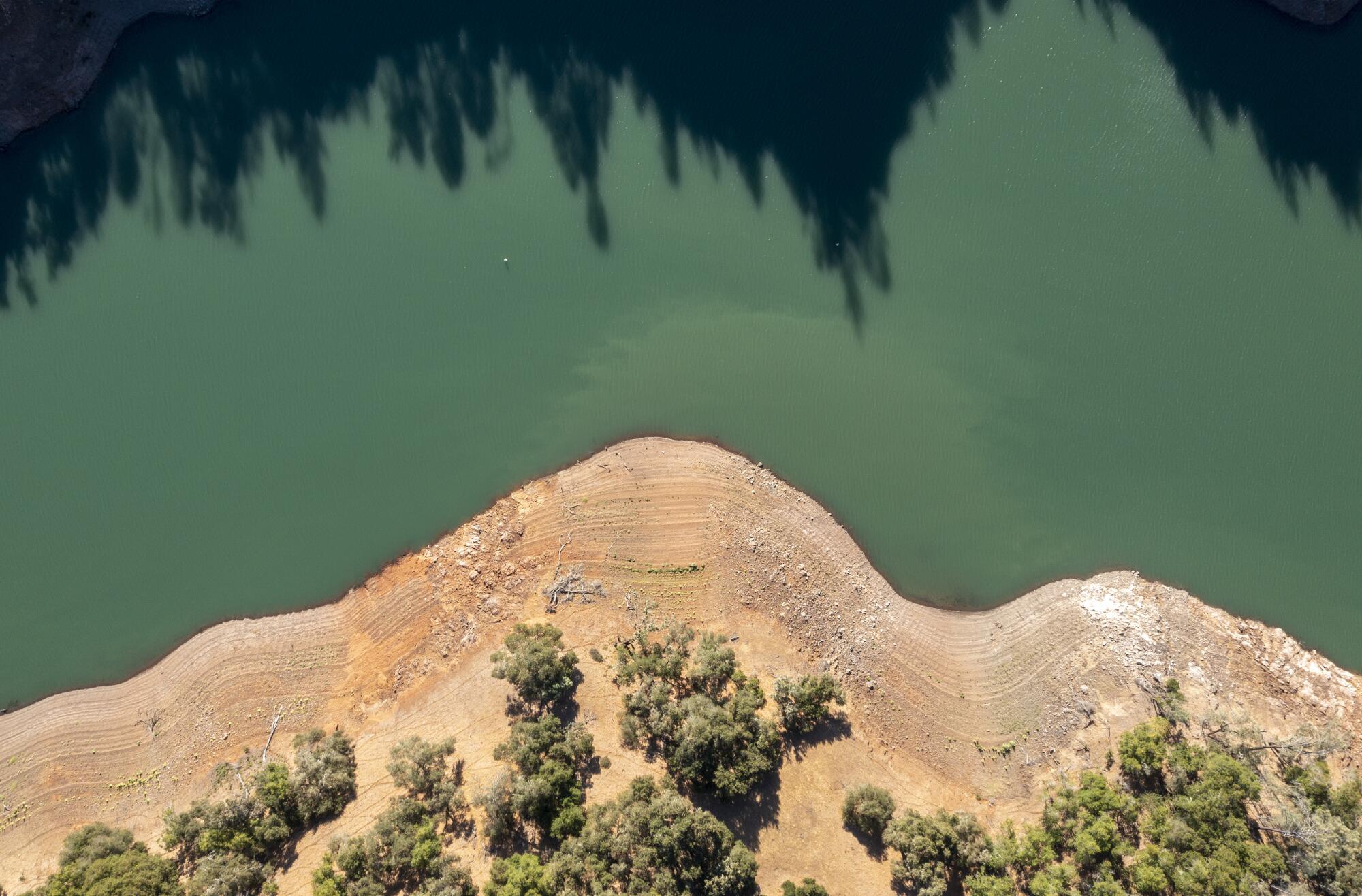 Land once underwater is exposed by receding water levels on Lake Sonoma in Geyserville, Calif.