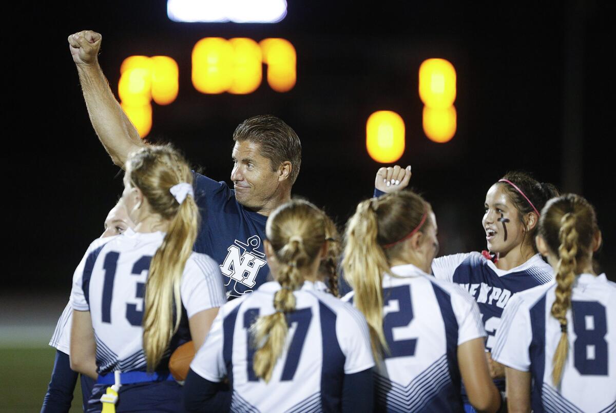 Newport Harbor girls' flag football coach Jason Guyser reacts to the cheering crowd on Wednesday.