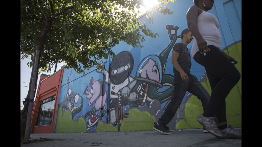 A Melrose Avenue sidewalk is brightened by a mural by Los Angeles graffiti artist Cache.