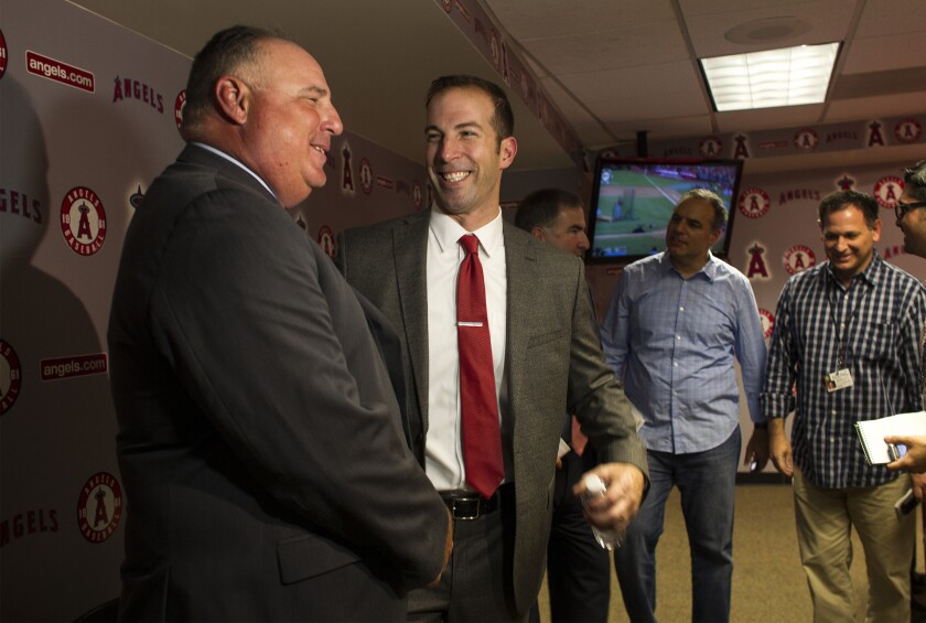 General Manager Billy Eppler, right, greets Manager Mike Scioscia after a news conference announcing Eppler as the Angels new GM at Angel Stadium.
