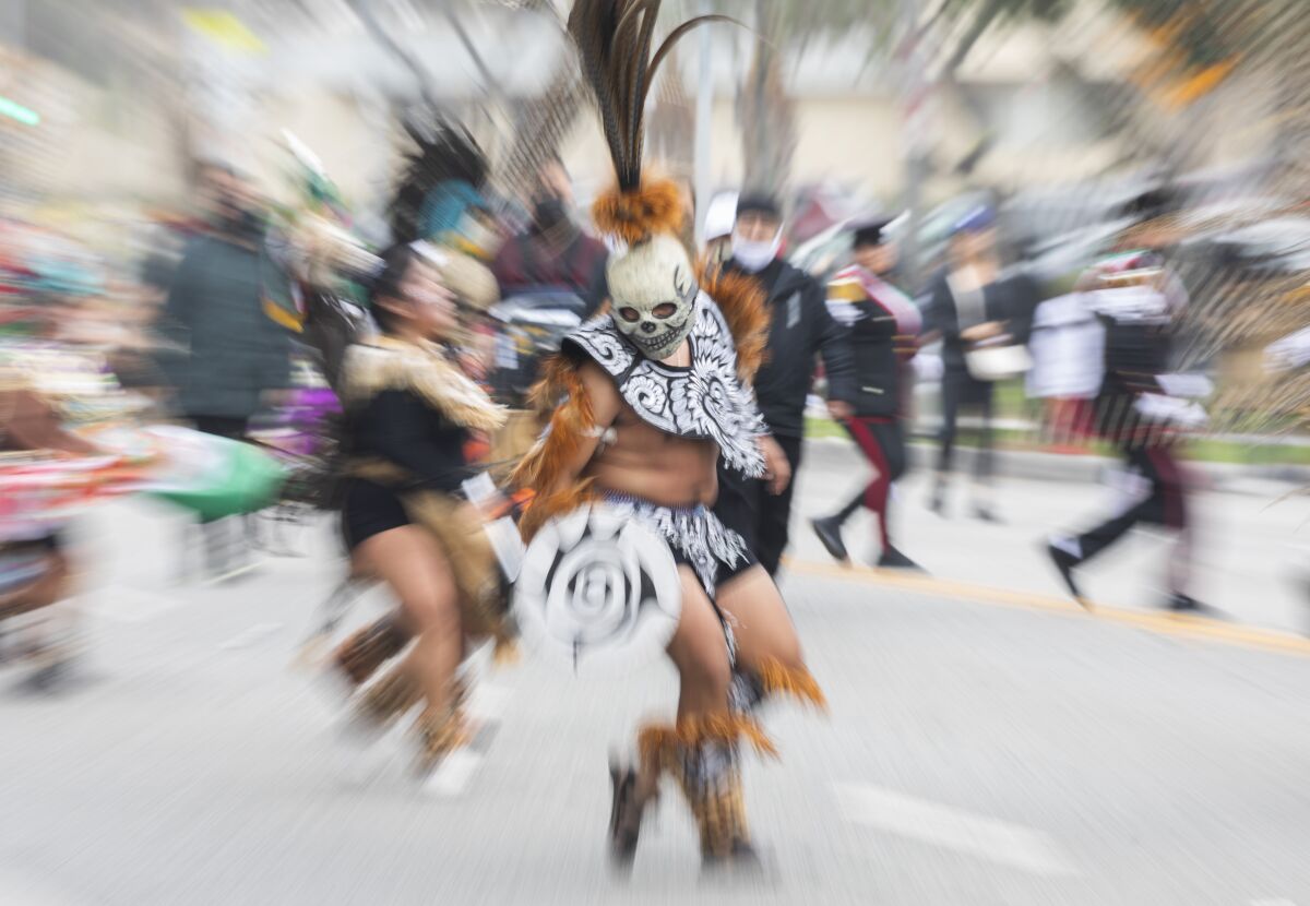 Blurring suggests movement in a photo of dancers in costume.