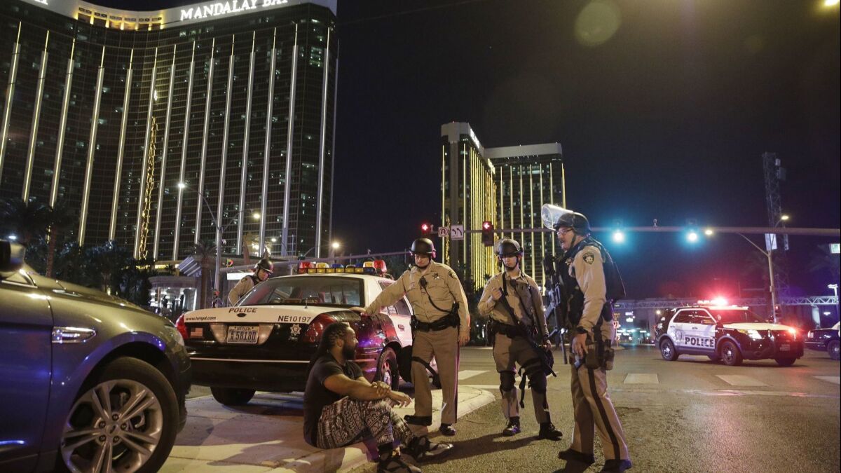 Officers gather at the scene of the Oct. 1 mass shooting near the Mandalay Bay casino in Las Vegas.