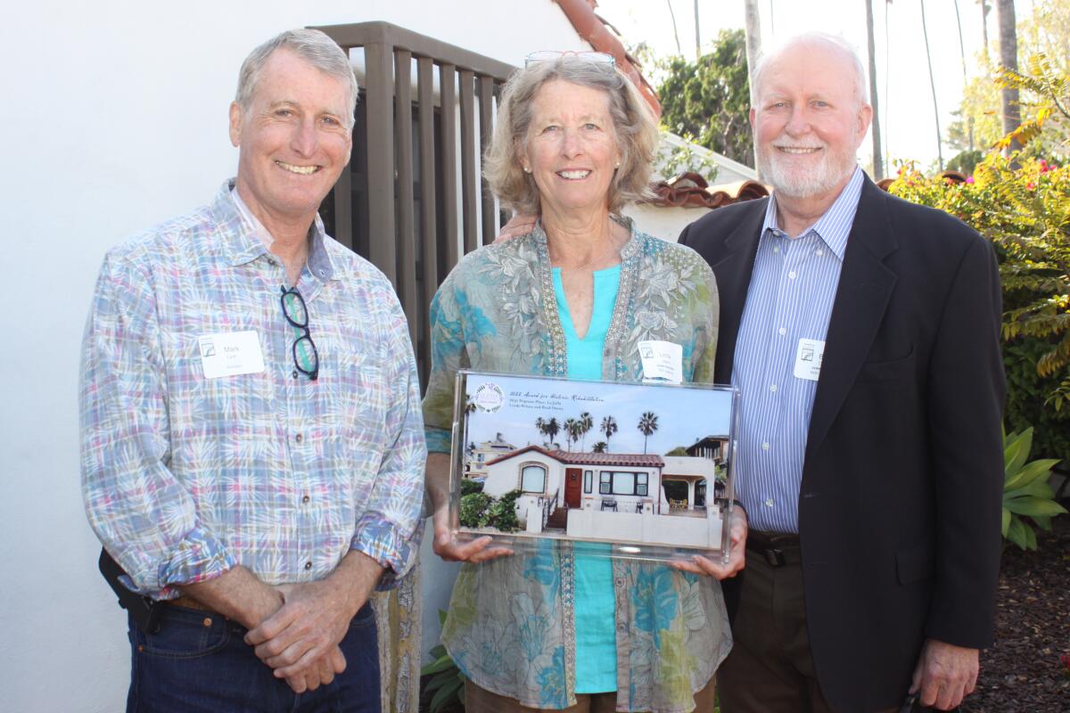 Architect Mark Lyon stands with Linda Wilson and Brad Owens, whose 6631 Neptune Place won the Jewel Award for Rehabilitation.