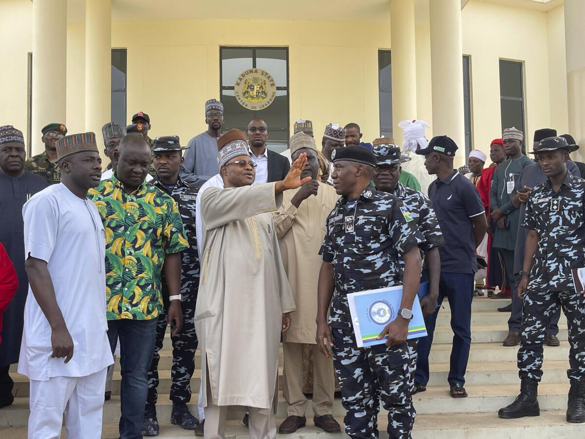 A Nigerian state governor gathers with people in uniform.