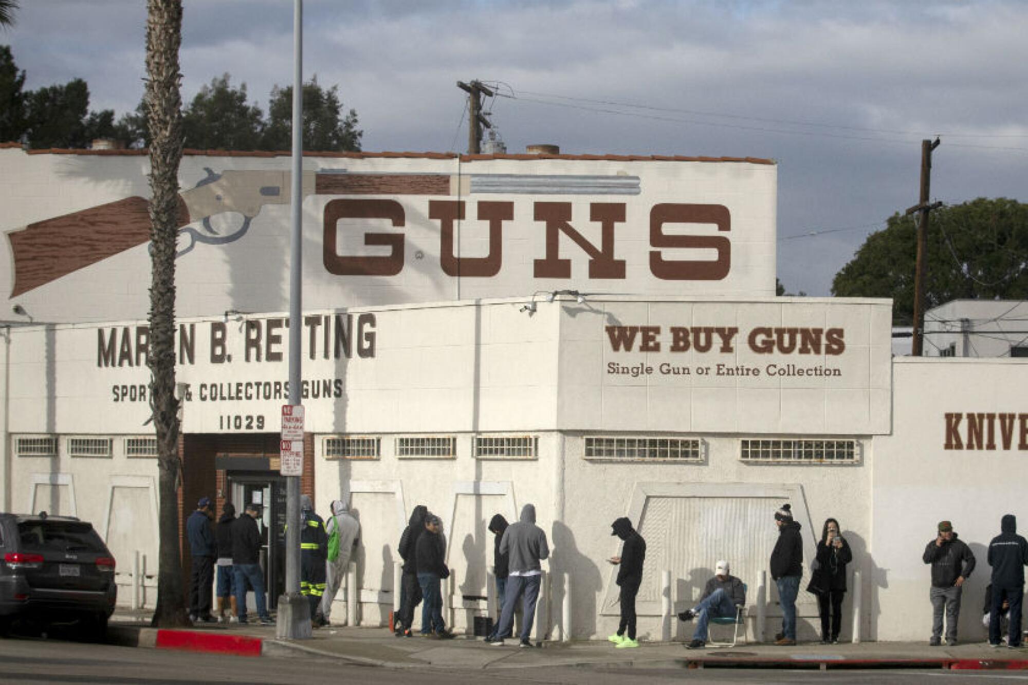 A line of people stand outside the Martin B. Retting gun store in Culver City in March 2020