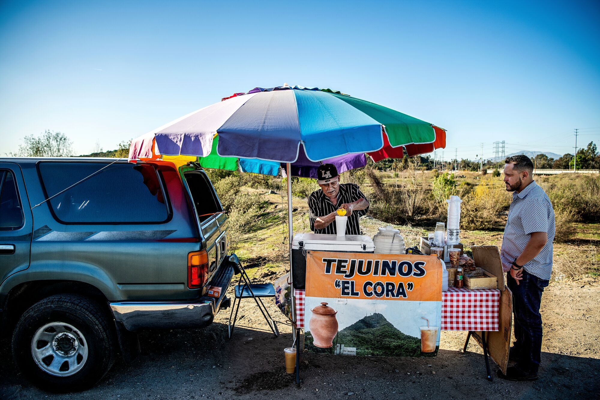 A customer visits a Tejuino vendor on Rosemead Blvd.