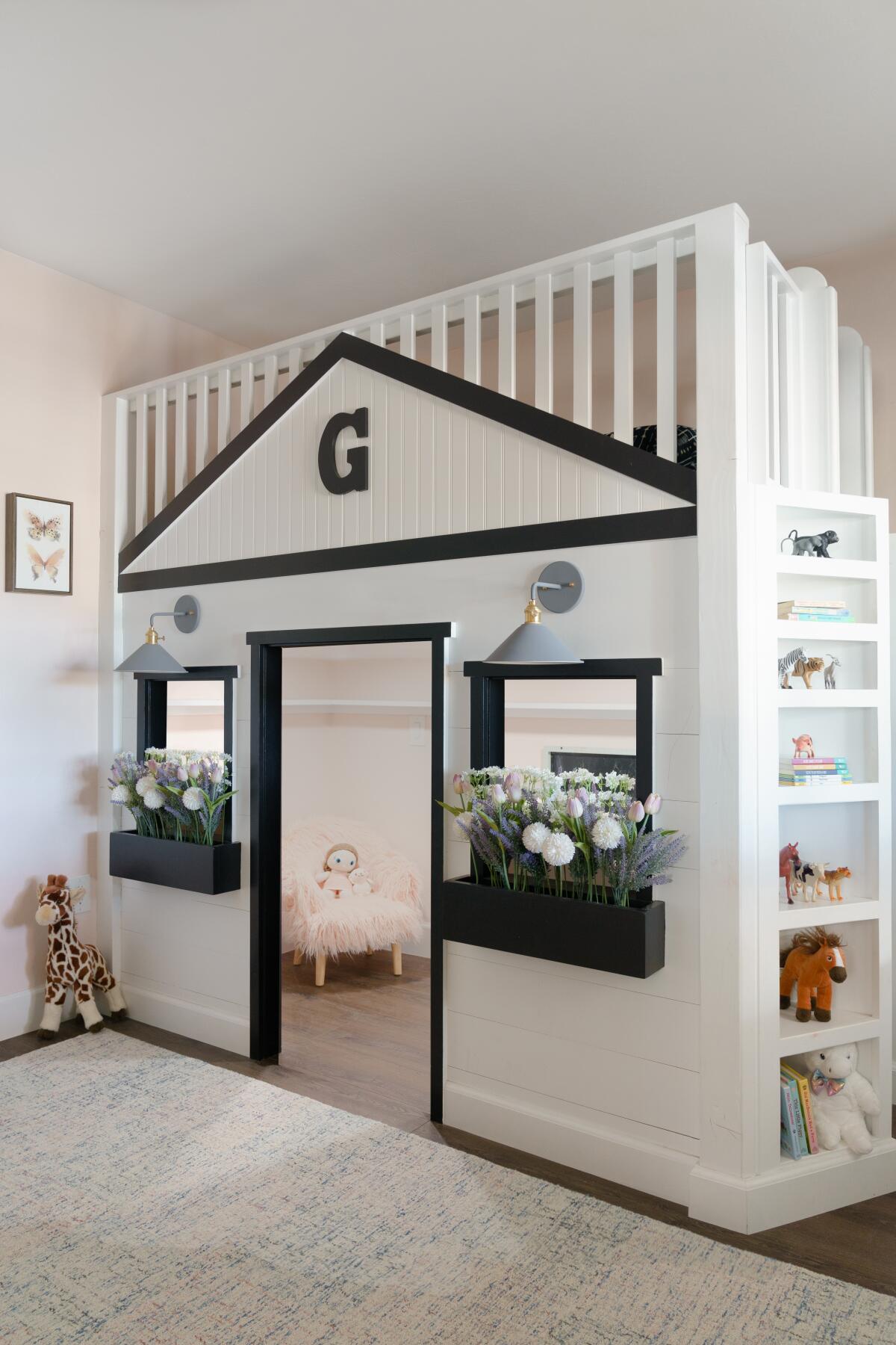Built-ins provide smart storage for books and toys alongside the playhouse in the "farmhouse luxe" girls room.