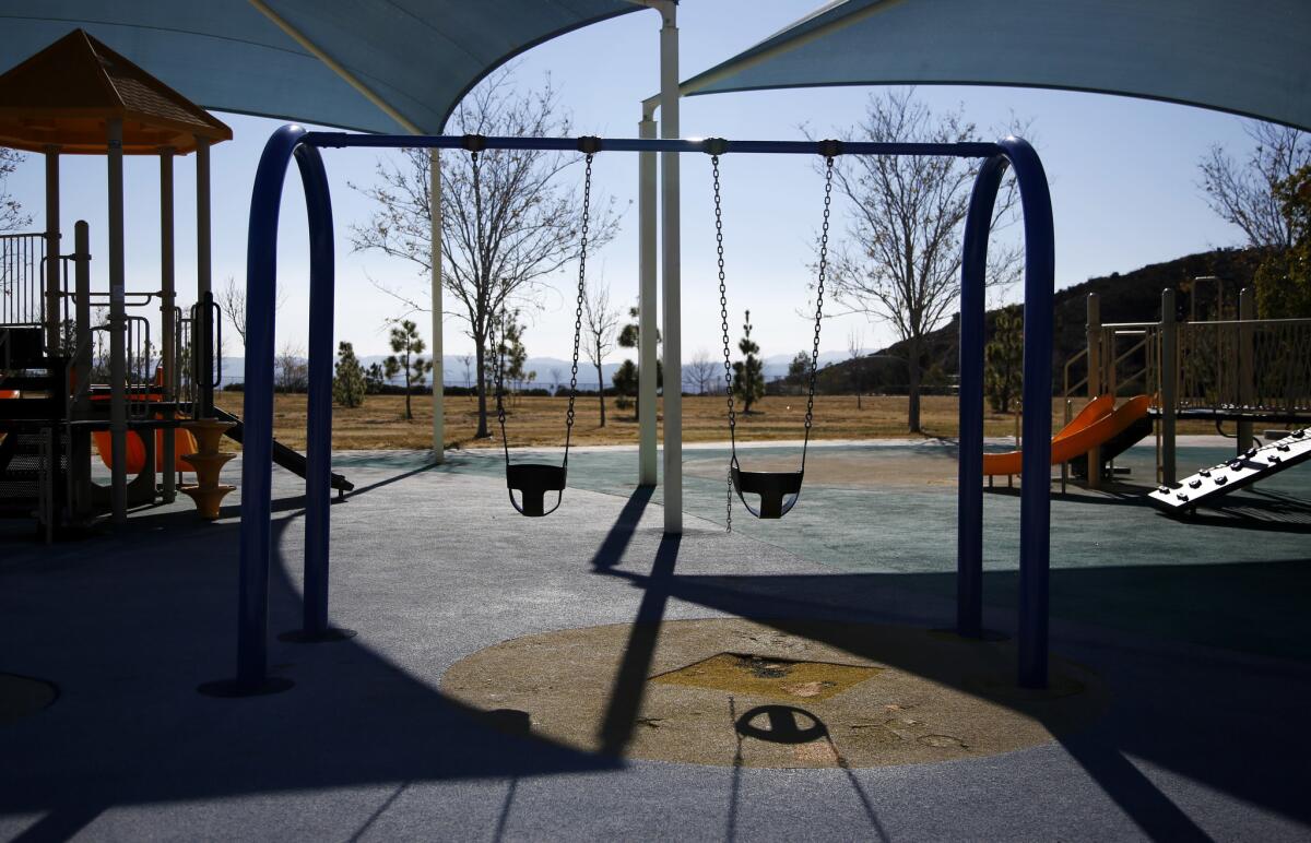 A playground sits empty at a park in Porter Ranch.