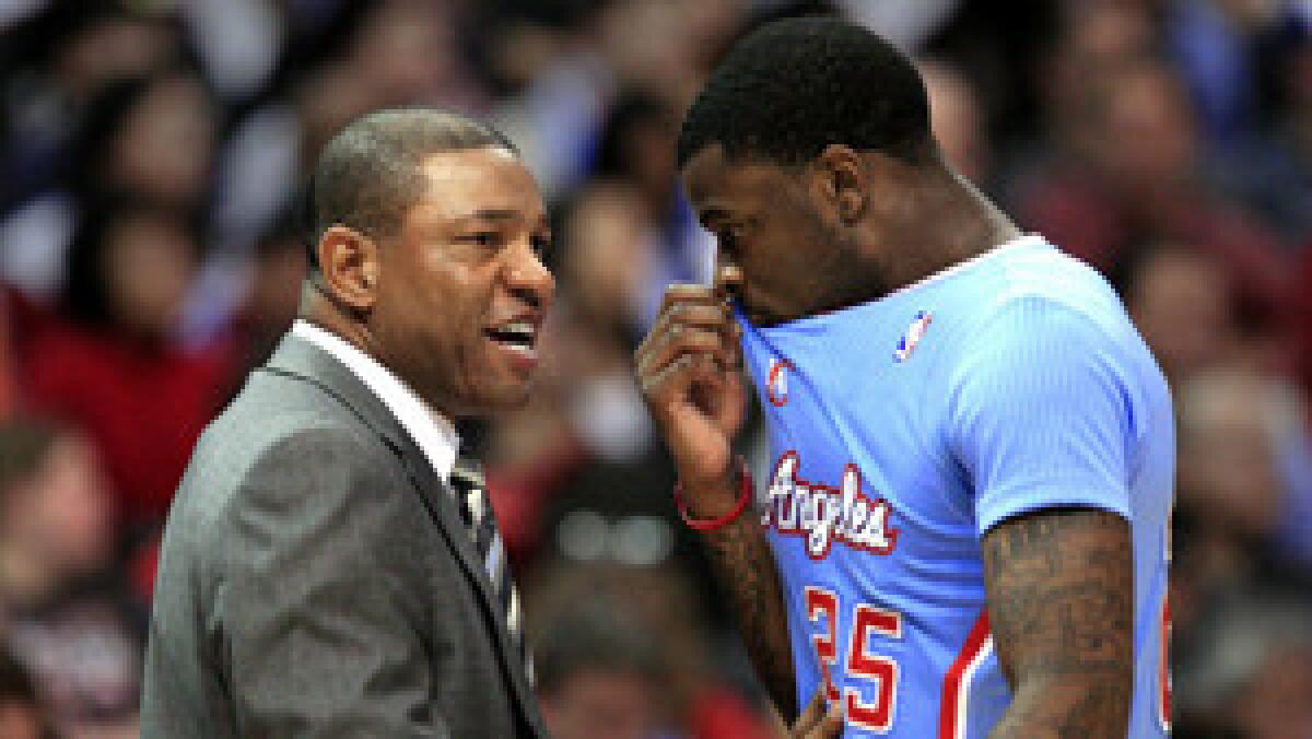 Clippers head coach Doc Rivers talks with Clippers guard Reggie Bullock during their game with the Bulls at the Staples Center Sunday, Nov. 24, 2013. Clippers won 121-82, their biggest point-margin win in Clippers' history.