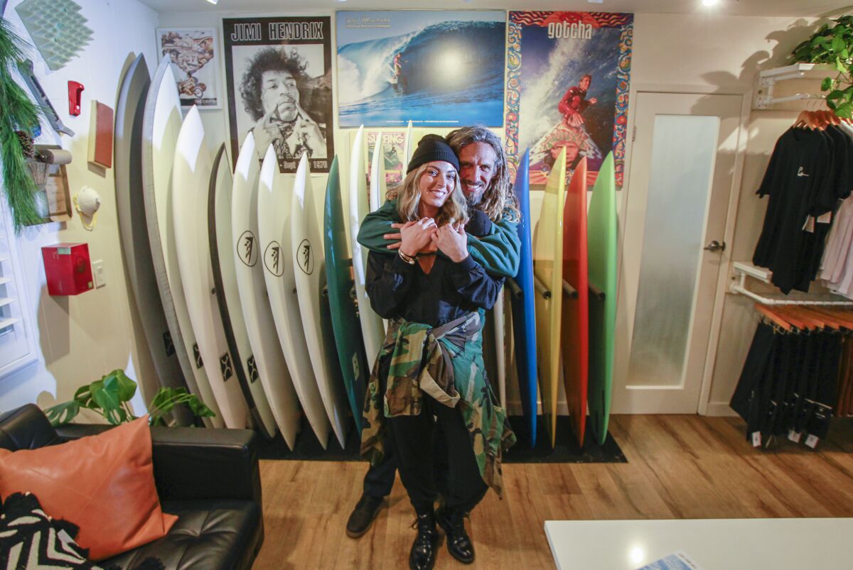 Surfing legend Rob Machado (right) and his wife Sofie Machado pose for photos at The Salty Garage on November 8, 2019 in Encinitas, California. Machado now shapes custom surfboards.