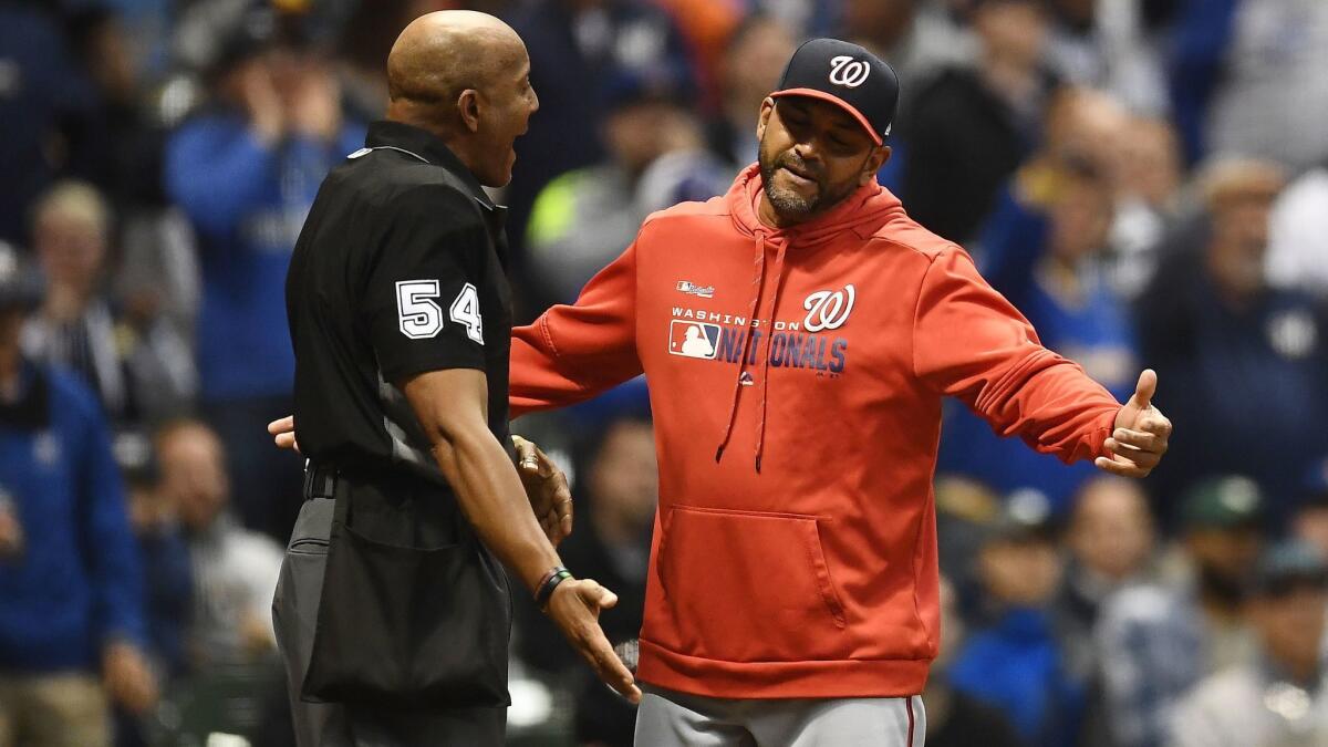 Washington Nationals manager Dave Martinez argues a call with umpire CB Bucknor during a game against the Milwaukee Brewers on May 7 at Miller Park.