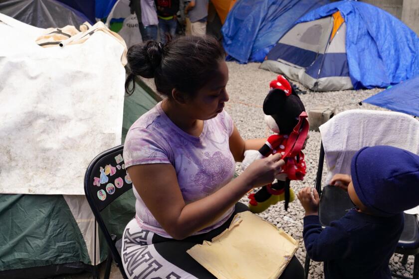 At a local shelter in Tijuana, Karen (prefers not to use her last name) tends to her youngest child. Karen who is from Honduras has requested asylum for herself and her three children in the U.S., and waits in Tijuana for her court date in the U.S.