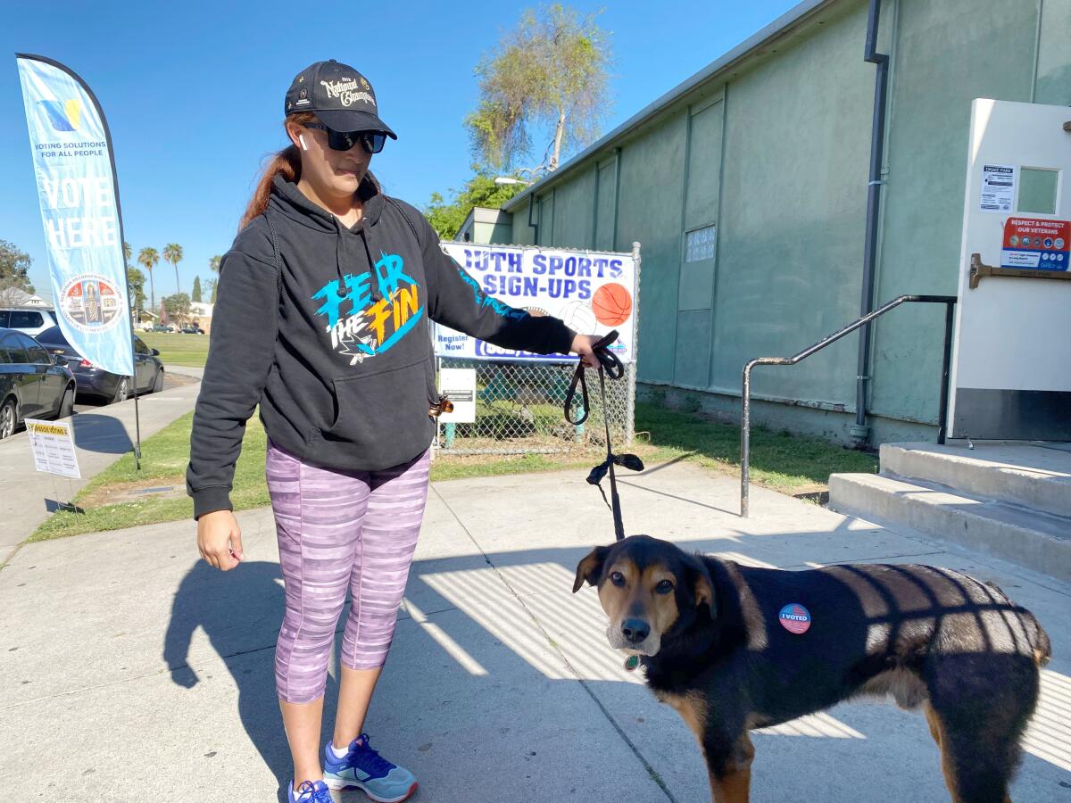 Elle Pratt of Long Beach brought her dog, Otto, with her to vote. 