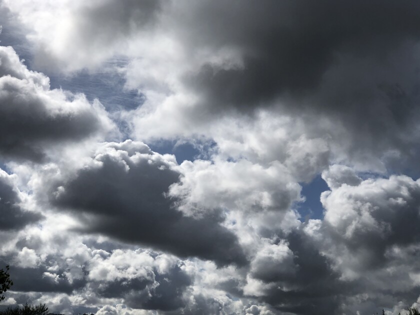 The rain clouds are moving out but the marine layer will stick around this weekend.