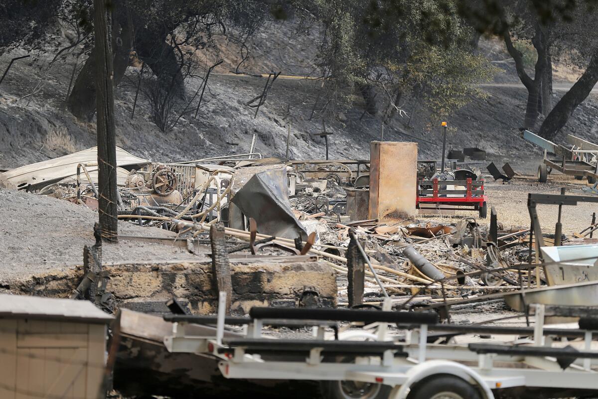 The remains of a structure and boats scorched by the Whittier fire sit along State Route 154 in Los Padres National Forest near Lake Cachuma in Santa Barbara County.