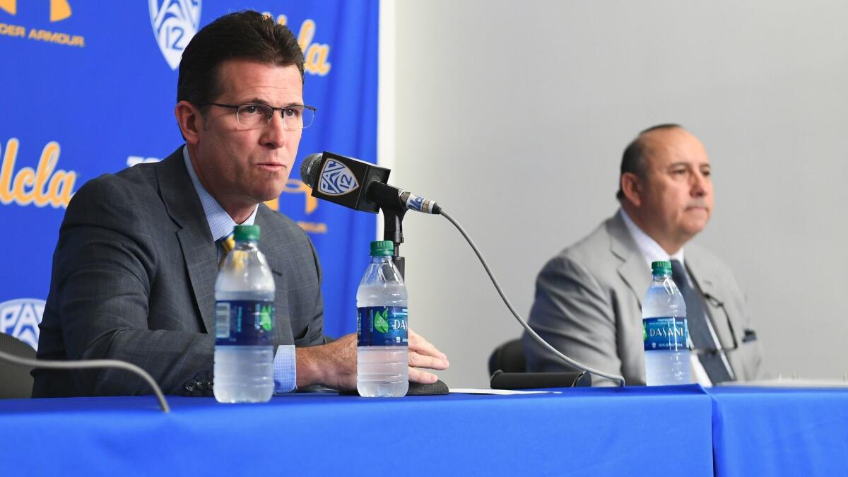 UCLA basketball coach Steve Alford, left, speaks about the arrests of three of his players in China as athletic director Dan Guerrero looks on during a news conference Wednesday at Pauley Pavilion.