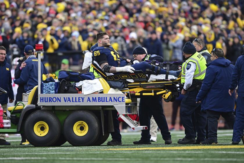 FILE - Michigan offensive lineman Zak Zinter is carted off the field after sustaining an injury during the second half of an NCAA college football game against Ohio State Nov. 25, 2023, in Ann Arbor, Mich. In the third round of the NFL draft Friday, April 26, 2024, the Cleveland Browns picked Zinter who broke his left leg against Ohio State in November when Buckeyes defensive tackle Michael Hall Jr., taken by the Browns in the second round, was accidentally throw into him. (AP Photo/David Dermer, File)