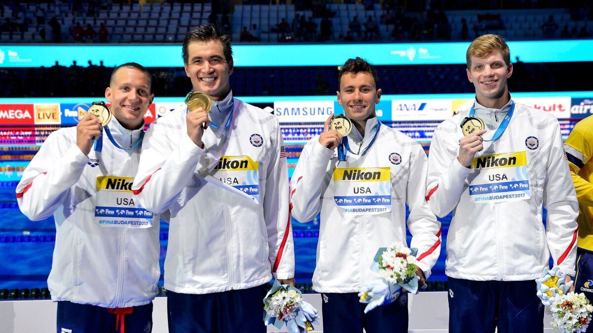 The U.S. team of Caeleb Dressel, from left, Nathan Adrian, Blake Pieroni and Townley Haas show off their gold medals after winning the 400-meter relay at the swimming world championships in Budapest, Hungary, on July 23, 2017.