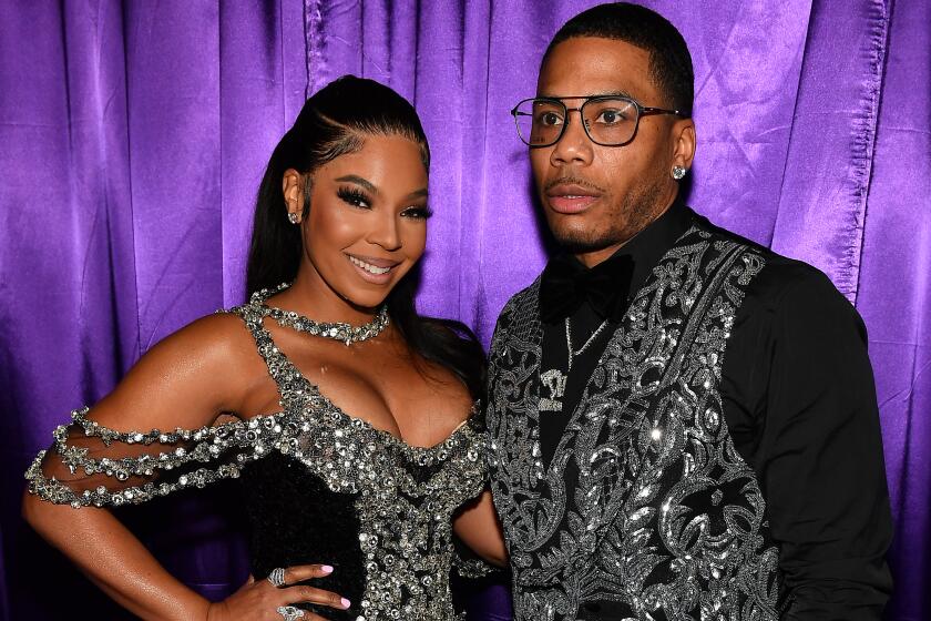 Ashanti smiles in a glitter gown with rappy Nelly