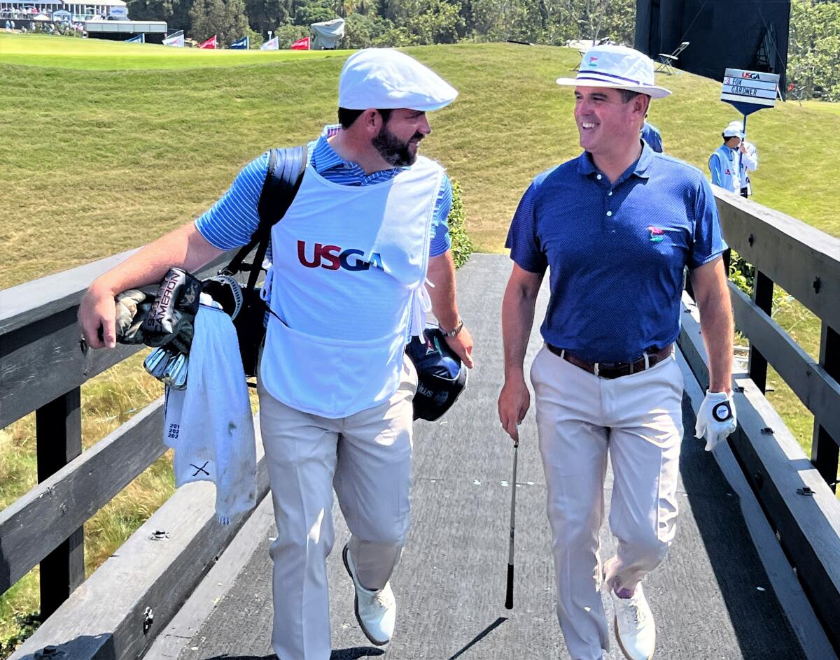 LACC director of golf Tom Gardner, right, walks across the bridge at No. 9 with Rory Sweeney, LACC's head pro and his caddie.