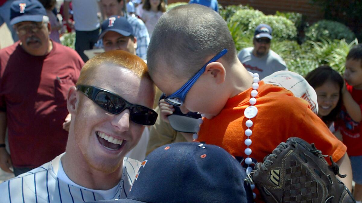 Justin Turner, left, greets young Cal State Fullerton fan Joseph McGuire in 2004.