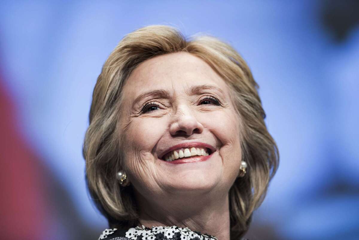 Former Secretary of State Hillary Clinton smiles before speaking at the World Bank in Washington, DC.