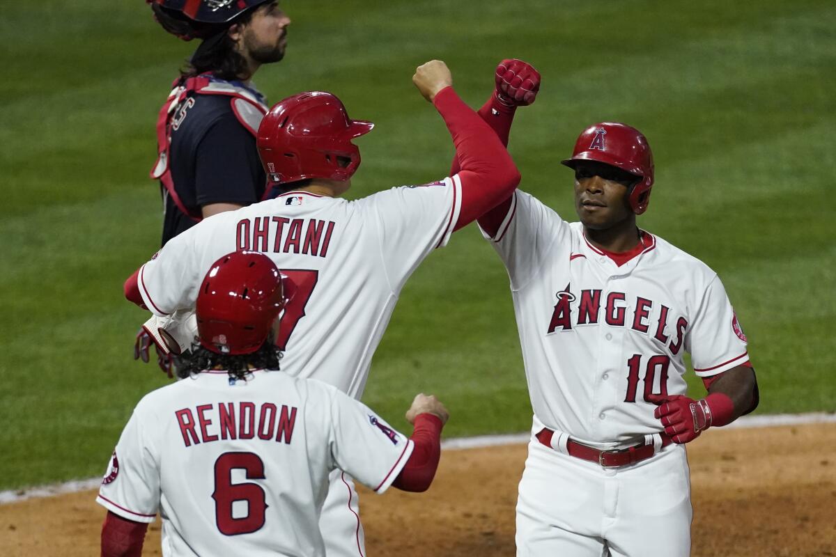 Angels' Justin Upton celebrates with designated hitter Shohei Ohtani and Anthony Rendon.