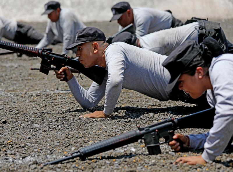 Cadets on the ground with rifles.