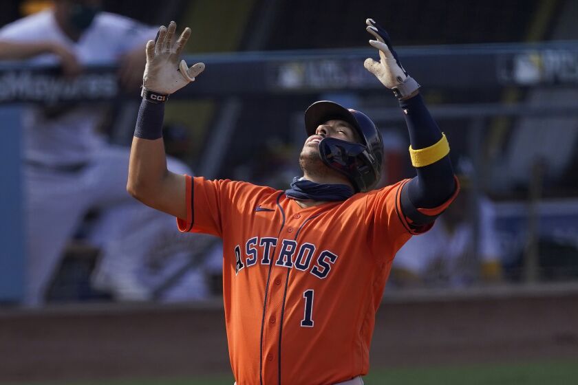 Houston Astros' Carlos Correa celebrates after hitting a solo home run against the Oakland Athletics during the seventh inning of Game 1 of a baseball American League Division Series in Los Angeles, Monday, Oct. 5, 2020. (AP Photo/Ashley Landis)