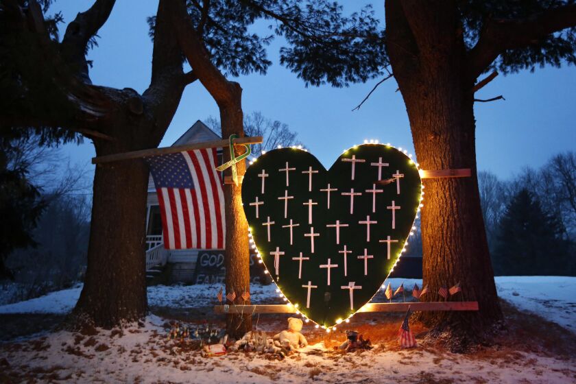 FILE - A makeshift memorial with crosses for the victims of the Sandy Hook Elementary School shooting massacre stands outside a home on the first anniversary of the tragedy in Newtown, Conn., Dec. 14, 2013. Connecticut lawmakers on Thursday, May 25, 2023, were considering the most wide-ranging package of gun safety measures since the legislation passed after the 2012 Sandy Hook school massacre, with proponents noting the state is not “recklessly retreating” from regulating guns like other states. (AP Photo/Robert F. Bukaty, File)