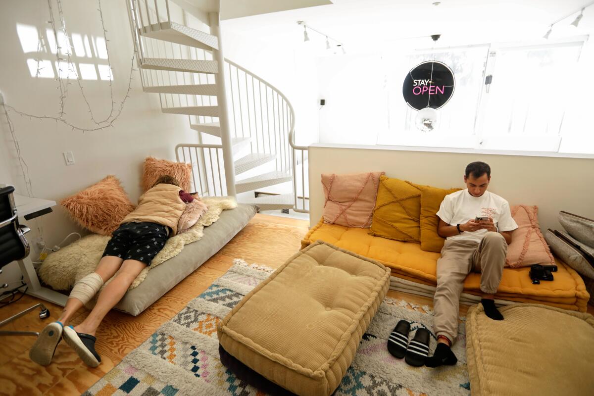 Two people lounging in a loft.