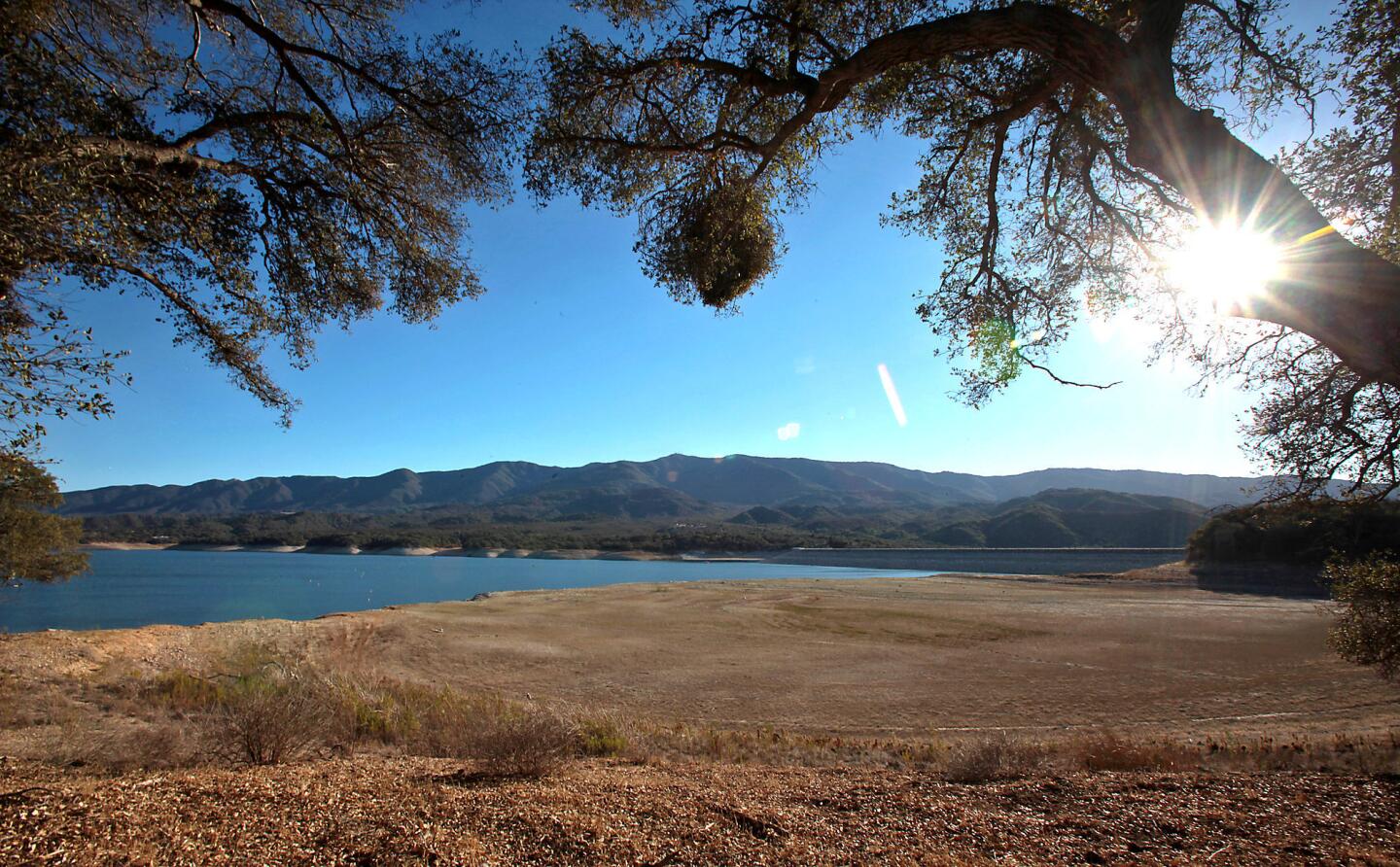 Cachuma Lake's previous shoreline is brown and dry as the water level continues to drop because of sustained drought conditions.