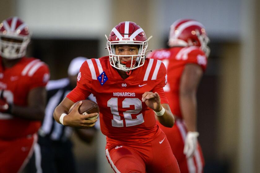 Duncanville, TX - August 27: Mater Dei Monarchs quarterback Elijah Brown (12) runs for a first down against the Duncanville Panthers during the game in Panther Stadium on Friday, Aug. 27, 2021 in Duncanville, TX. (Jerome Miron / For the LA Times)