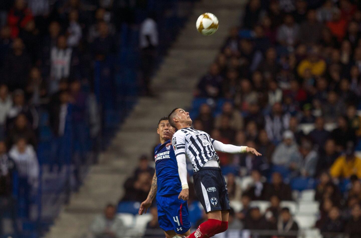 Monterrey's Argentinian foward Rogelio Funes Mori (R) jumps for a header with Cruz Azul's Mexican defender Julio Dominguez (L) during the first leg of the semifinal of the Mexican Apertura 2018 tournament football, match at the BBVA Bancomer stadium in Monterrey, Mexico on December 5, 2018. (Photo by Julio Cesar AGUILAR / AFP)JULIO CESAR AGUILAR/AFP/Getty Images ** OUTS - ELSENT, FPG, CM - OUTS * NM, PH, VA if sourced by CT, LA or MoD **