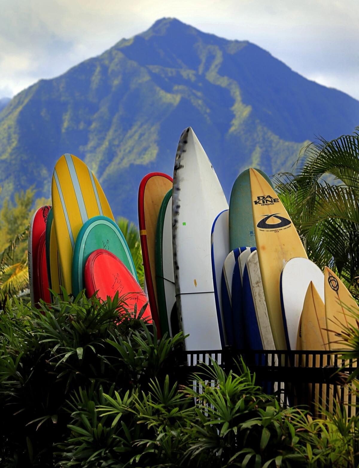 Surfboards and paddle boards for guests are stacked together at the St. Regis Princeville resort.