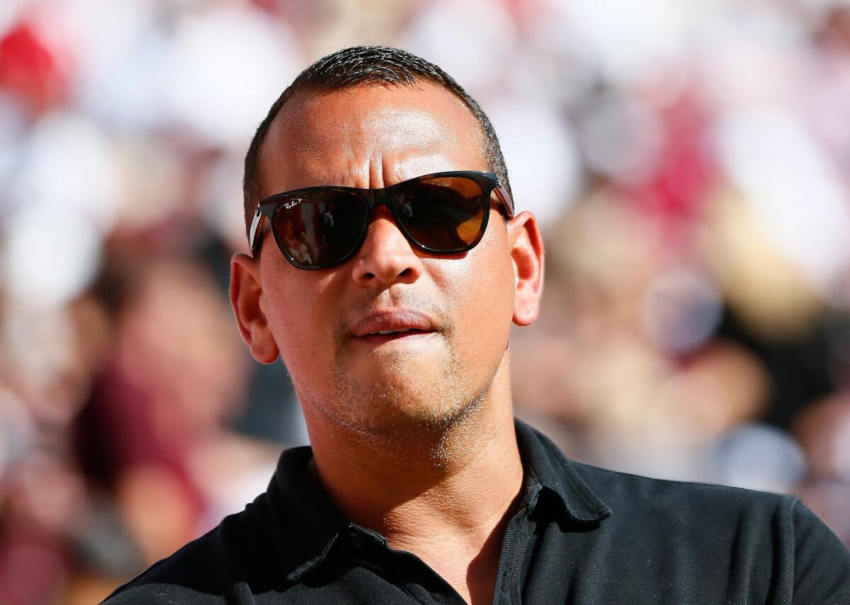 Alex Rodriguez stands on the sidelines before an Oct. 18 college football game between Alabama and Texas in Tuscaloosa, Ala.