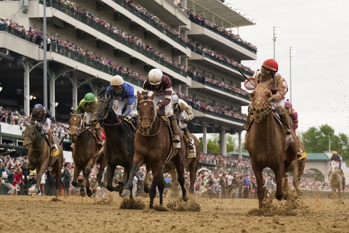Rich Strike, front right, with Sonny Leon aboard, wins the 148th running of the Kentucky Derby horse race at Churchill Downs Saturday, May 7, 2022, in Louisville, Ky. (AP Photo/Jeff Roberson)