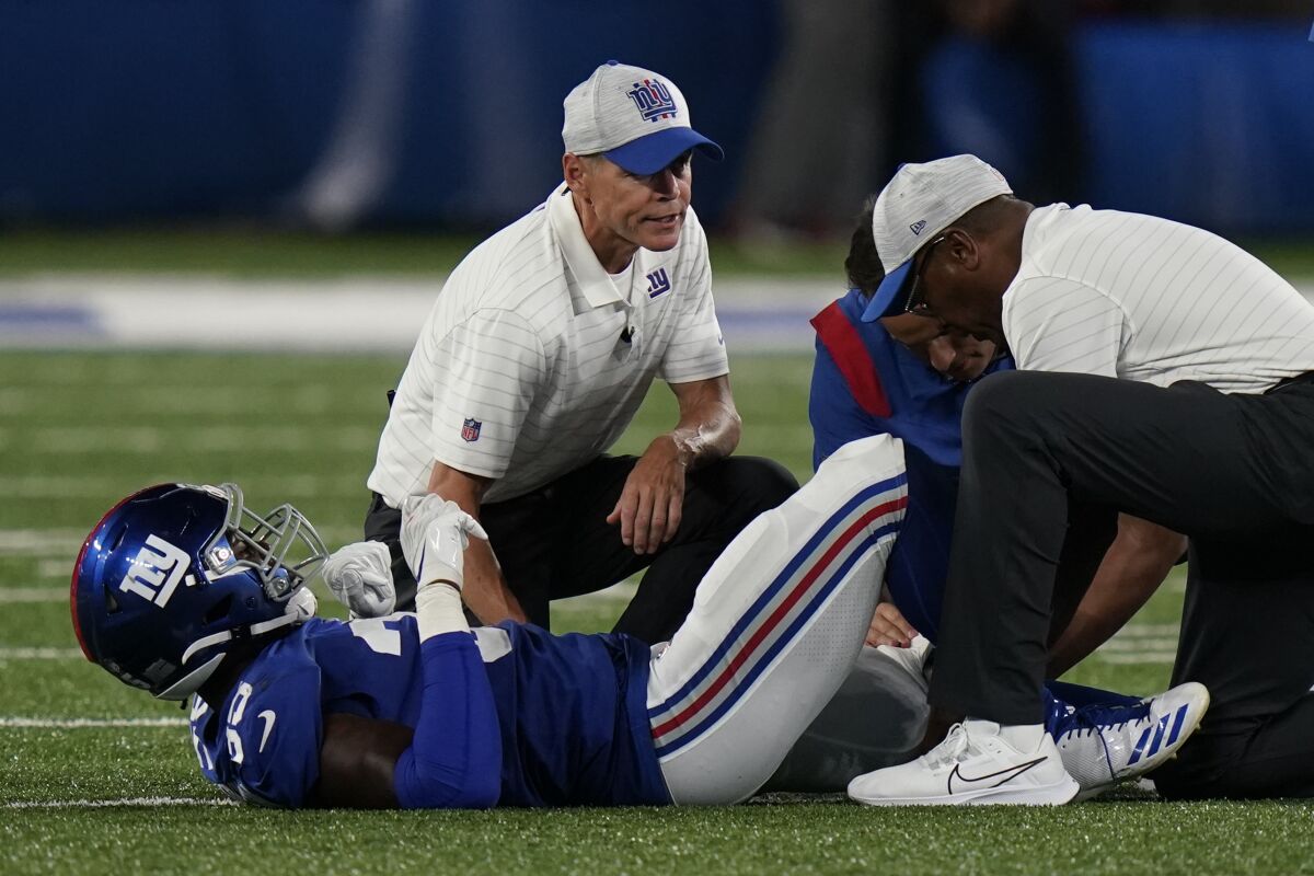 New York Giants linebacker T.J. Brunson likes on the field after an apparent injury in the second half of an NFL preseason football game against the New York Jets, Saturday, Aug. 14, 2021, in East Rutherford, N.J. (AP Photo/Frank Franklin II)