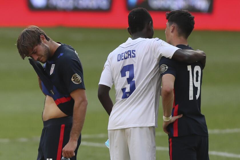 Honduras' Wesly Decas, center, comforts United States' Sebastian Soto, right, beside Ulysses Llanez at the end.