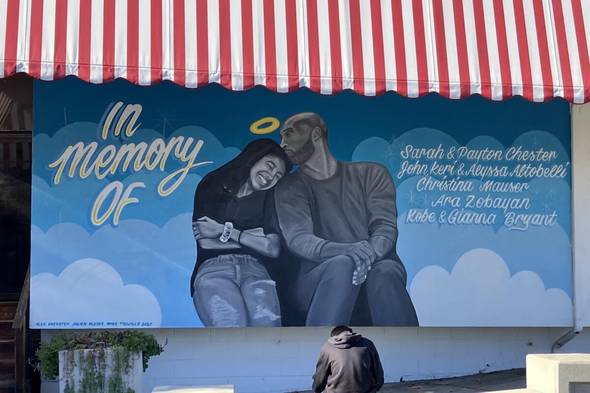 A mural outside Golden Spoon yogurt shop shows Kobe and Gianna Bryant sitting together with Kobe kissing the top of her head.