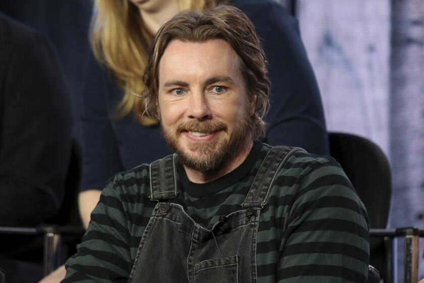 Dax Shepard in a striped shirt and overalls
