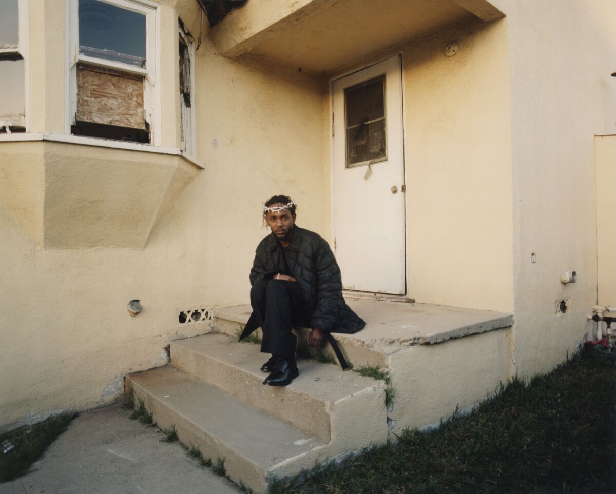 A man in a crown of thorns sits a stoop
